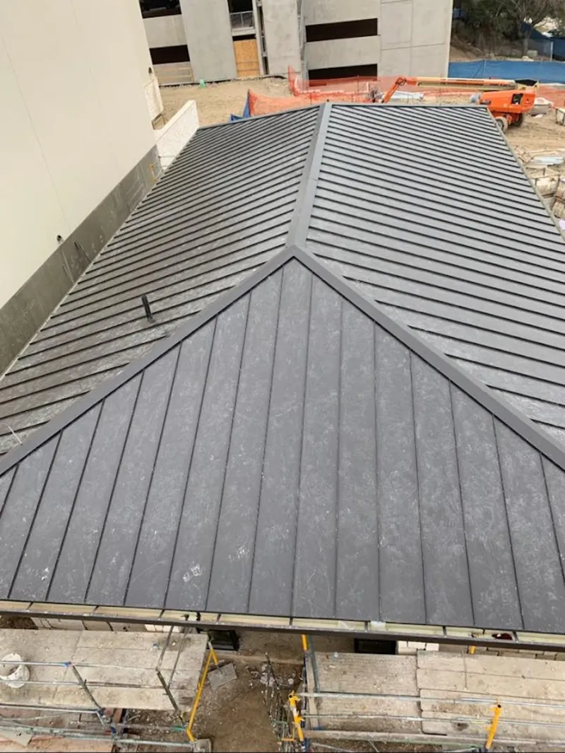 Commercial metal roof construction with crane equipment in Citrus Heights